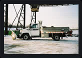 Medium sized salter truck with snow plow