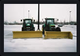 Farm tractors with snow pusher and snow plow